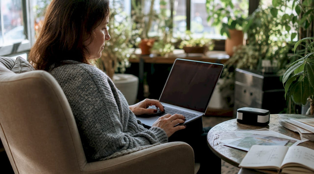 Woman checking custom print proofs on calibrated monitor
