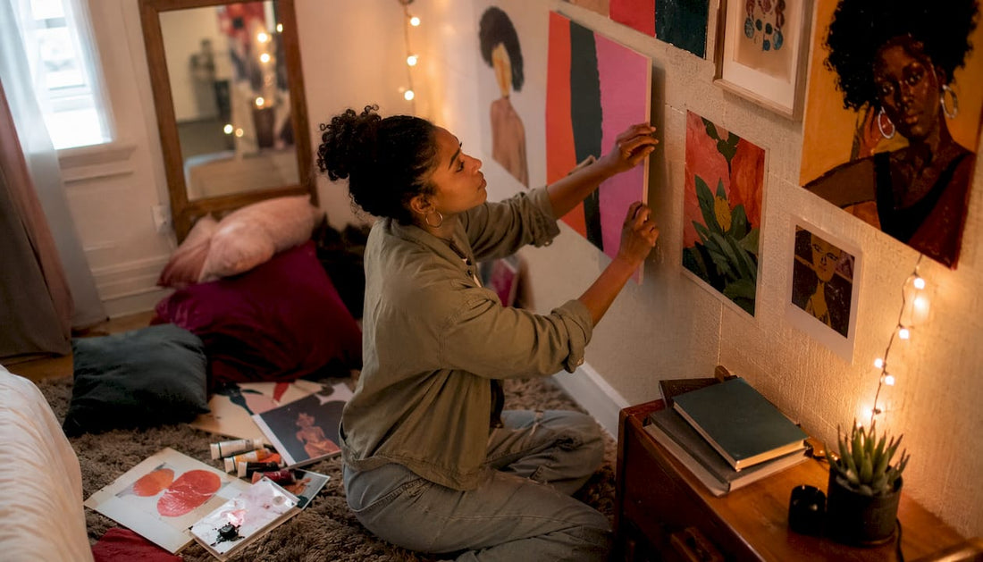 Woman arranging eclectic maximalist gallery wall art